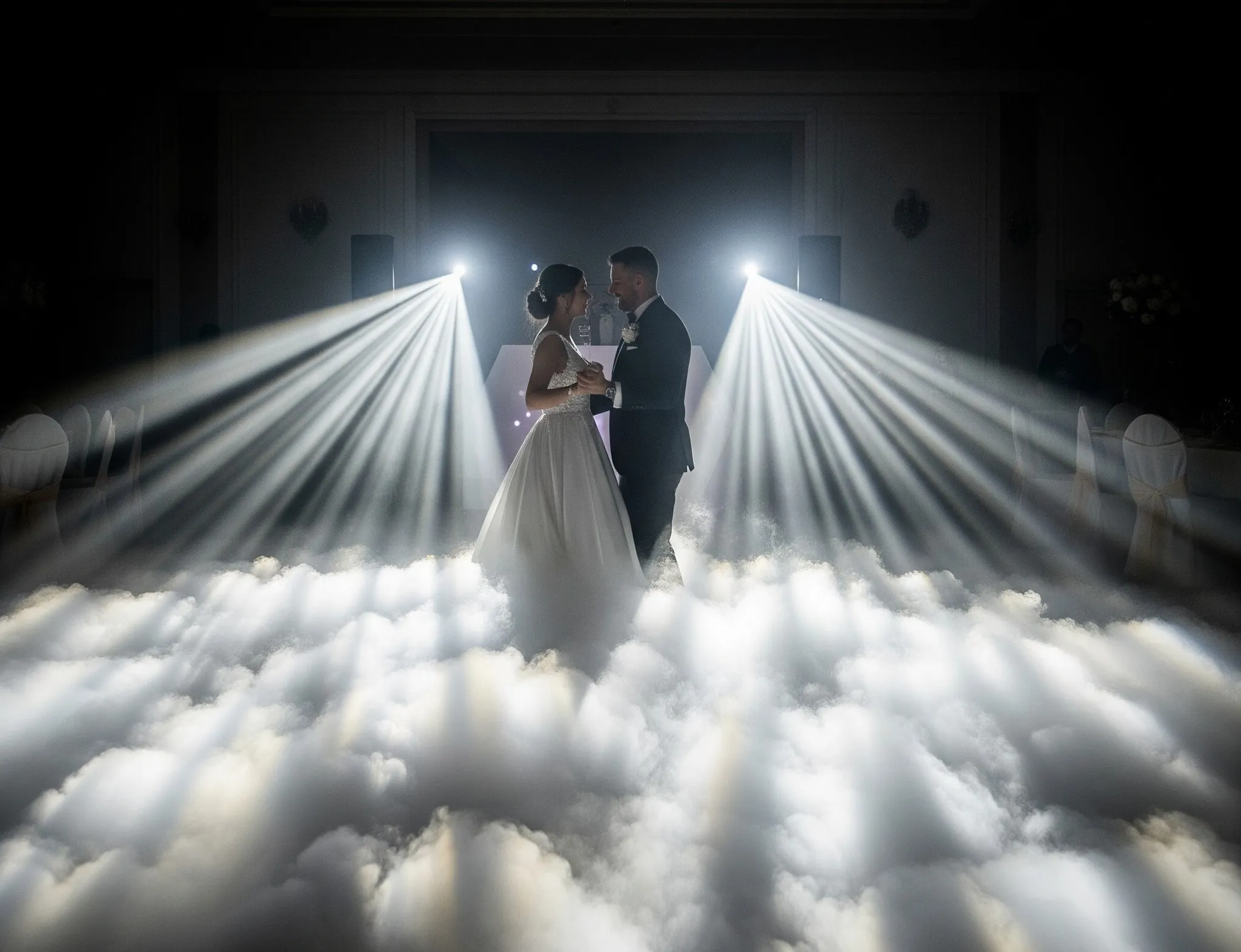 Novios bailando entre nubes de humo iluminadas